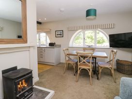 A kitchen dining area with a table and chairs at Windermere at the Graythwaite Estate near Hawkshead