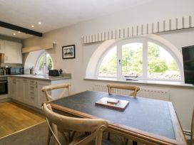 A kitchen with a table and chairs at Windermere at the Graythwaite Estate near Hawkshead