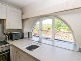 A kitchen with a sink and microwave at Windermere at the Graythwaite Estate near Hawkshead