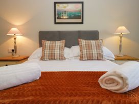 A bedroom with a bed and lamps at Windermere at the Graythwaite Estate near Hawkshead