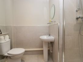 A bathroom with a sink, shower, and toilet at Windermere at the Graythwaite Estate near Hawkshead