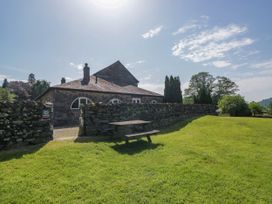 An outdoor area with a stone building and a picnic table at Windermere at the Graythwaite Estate near Hawkshead