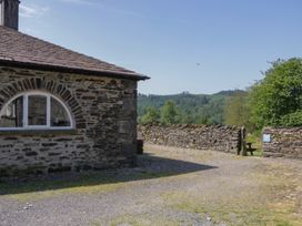 An outdoor area with a stone building and gravel path at Windermere at the Graythwaite Estate near Hawkshead