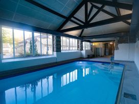 An indoor pool with large windows and seating at Briar in Graythwaite near Hawkshead
