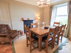 A dining room with a table and chairs at High Torver House in Torver