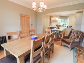A dining room with a table and chairs at High Torver House in Torver