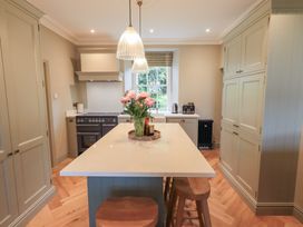 A kitchen with an island and kitchen appliances at High Torver House in Torver