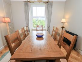A dining room with a table and chairs at High Torver House in Torver
