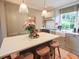 A kitchen with a sink and island at High Torver House in Torver