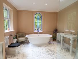 A bathroom with a bathtub and sink at High Torver House in Torver