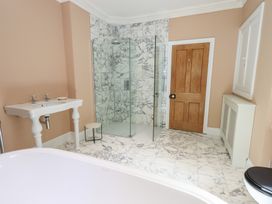 A bathroom with a shower, sink, and bathtub at High Torver House in Torver