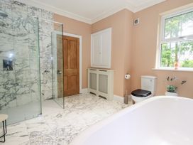 A bathroom with a shower and bathtub at High Torver House in Torver