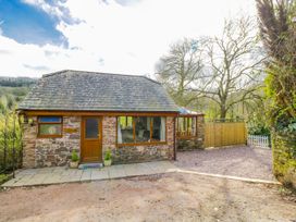 A house with stone walls and a patio at Calcott Annexe in Whitchurch, Herefordshire