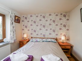 A bedroom with a bed and lamps at Calcott Annexe, Whitchurch, Herefordshire