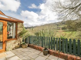 An outdoor area with a conservatory and a view of the landscape at Calcott Annexe Whitchurch Herefordshire