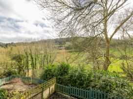A view of trees and grassy landscape from an outdoor area at Calcott Annexe in Whitchurch, Herefordshire