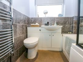 A bathroom with a toilet and sink at Pebbles Reach in Colwyn Bay