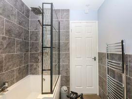 A bathroom with a bathtub and a shower at Pebbles Reach in Colwyn Bay