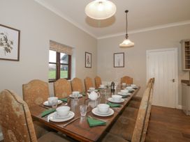 A dining room with a long table set for a meal at The Park in Ludlow