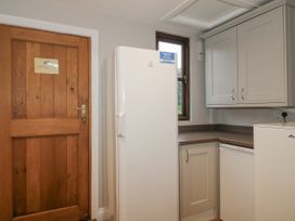 A kitchen with a refrigerator and cabinets at The Park in Ludlow