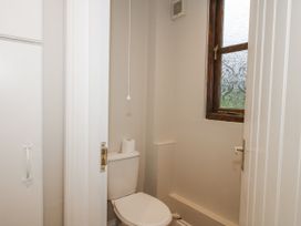 A bathroom with a toilet and a window at The Park in Ludlow
