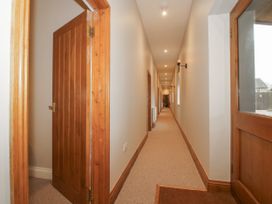 A hallway with doors and light fixtures at The Park in Ludlow
