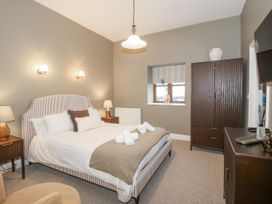 A bedroom with a bed, nightstand and wardrobe at The Park in Ludlow