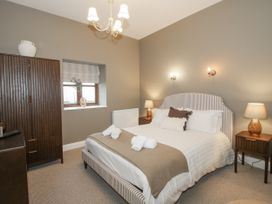 A bedroom with a bed and wardrobe at The Park in Ludlow