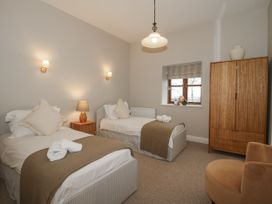 A bedroom with two beds and a wardrobe at The Park in Ludlow