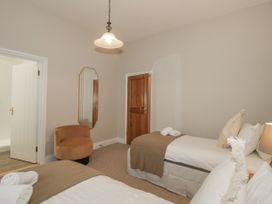 A bedroom with two beds and an armchair at The Park in Ludlow