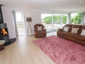 A living room with a sofa and fireplace at Atlantic View in Germoe