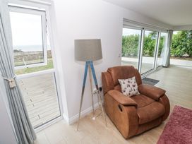 A living room with a recliner chair and a lamp at Atlantic View in Germoe
