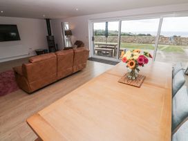 A living room with a sofa and dining table at Atlantic View in Germoe