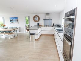 A kitchen with a dining table and appliances at Atlantic View in Germoe