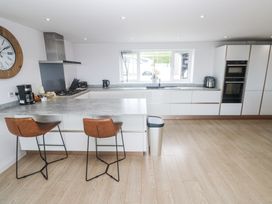 A kitchen with bar stools and counter space at Atlantic View in Germoe