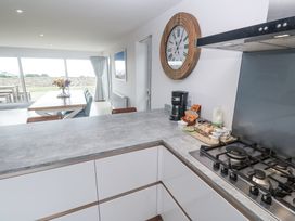 A kitchen with a counter gas stove and coffee maker at Atlantic View in Germoe