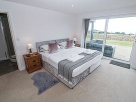 A bedroom with a bed and nightstand at Atlantic View in Germoe