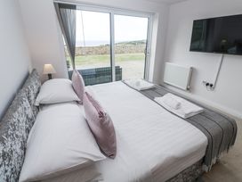 A bedroom with a bed and television at Atlantic View in Germoe