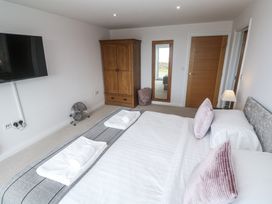 A bedroom with a bed and wardrobe at Atlantic View in Germoe