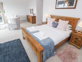 A bedroom with a bed and furniture at Atlantic View in Germoe