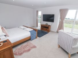 A bedroom with a bed and television at Atlantic View in Germoe