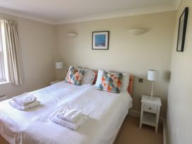 A bedroom with a double bed and bedside lamps at 4 Thurlestone Beach House in South Milton near Thurlestone