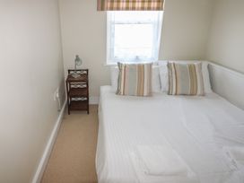 A bedroom with a bed and a bedside table at 4 Thurlestone Beach House in South Milton near Thurlestone