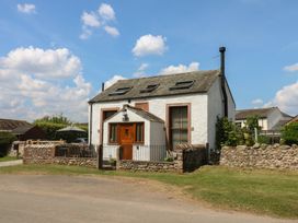 A house with a fence and garden at Chapel Cottage in Sandford, Cumbria