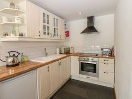 A kitchen with cabinets and appliances at Chapel Cottage in Sandford, Cumbria