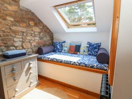 A snug room with a seating area and storage at Chapel Cottage in Sandford, Cumbria