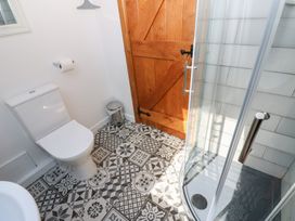 A bathroom featuring a toilet and shower at Chapel Cottage in Sandford, Cumbria