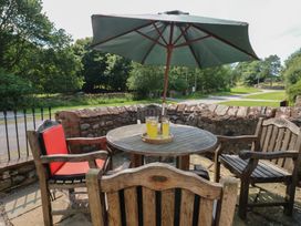 An outdoor seating area with a table and chairs at Chapel Cottage, Sandford, Cumbria