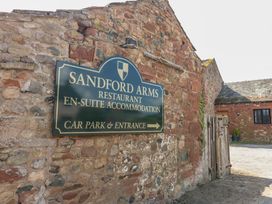 A sign for Sandford Arms restaurant and accommodation at Chapel Cottage Sandford, Cumbria