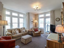 A living room with seating and a television at 2 York House in Dartmouth